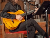 Close up of Fatih Bayram playing the guitar