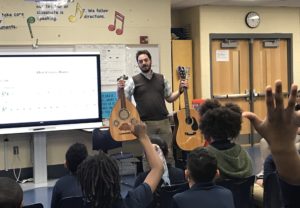 Choir and Music Skills Teacher Serge El Helou talks with eager students at Juniata about the difference between the oud and the guitar on February 25. Serge visited with three music classes thanks to Juniata music teacher Mr. Greco. 